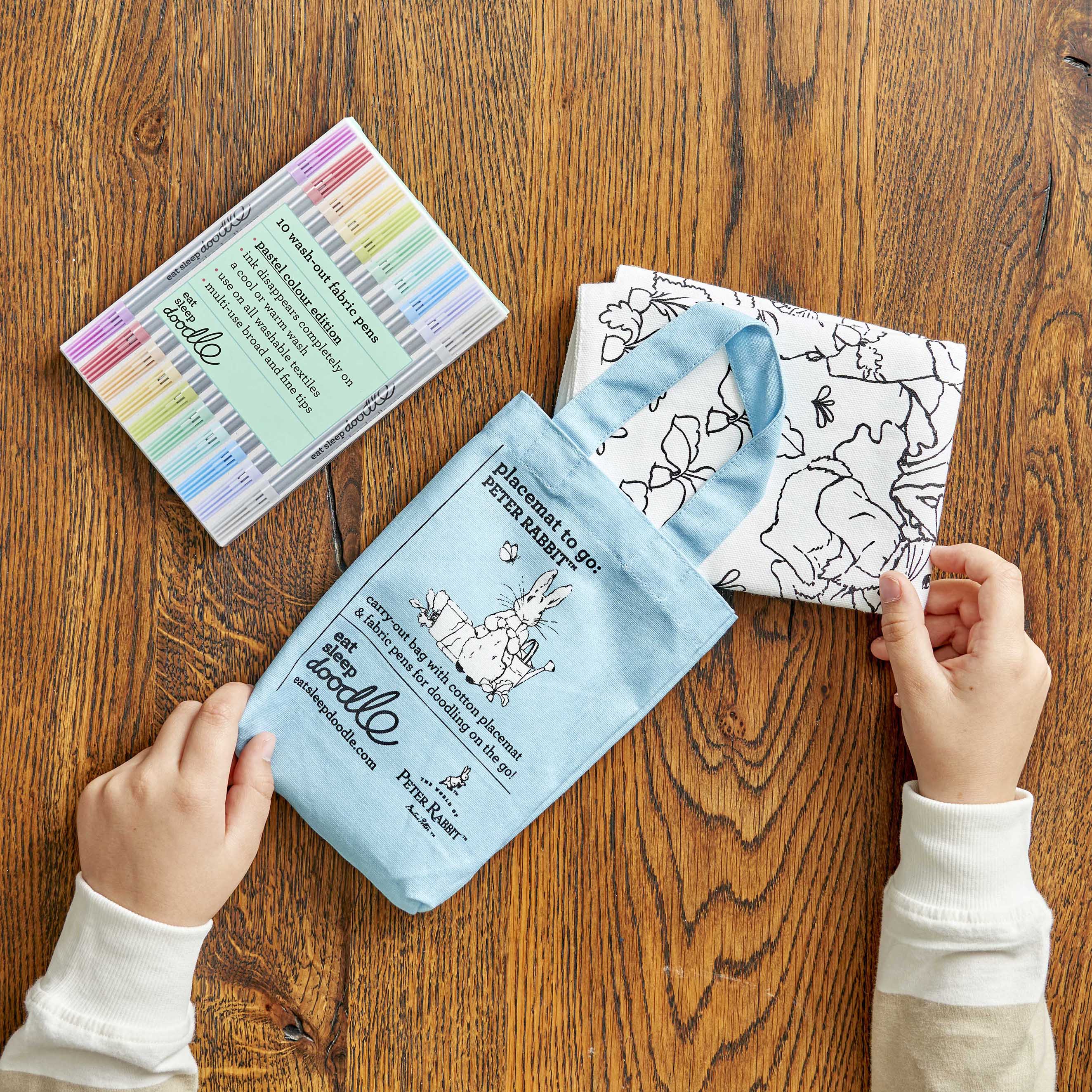 peter rabbit placemat folded and placed in blue carry bag