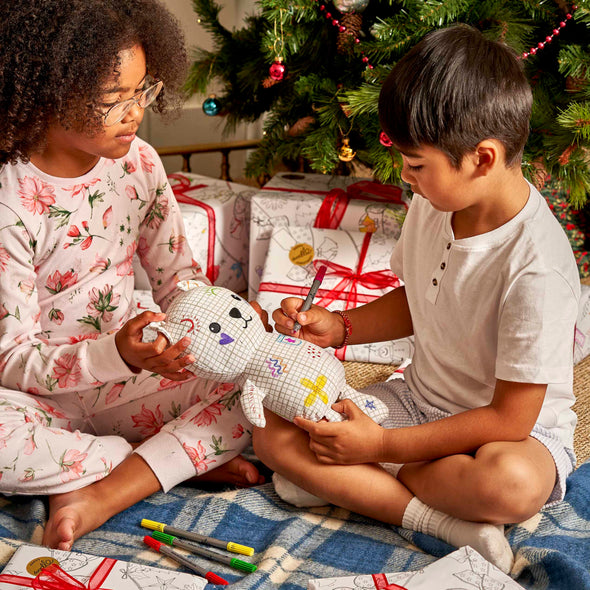 kids drawing on artie bear at christmas