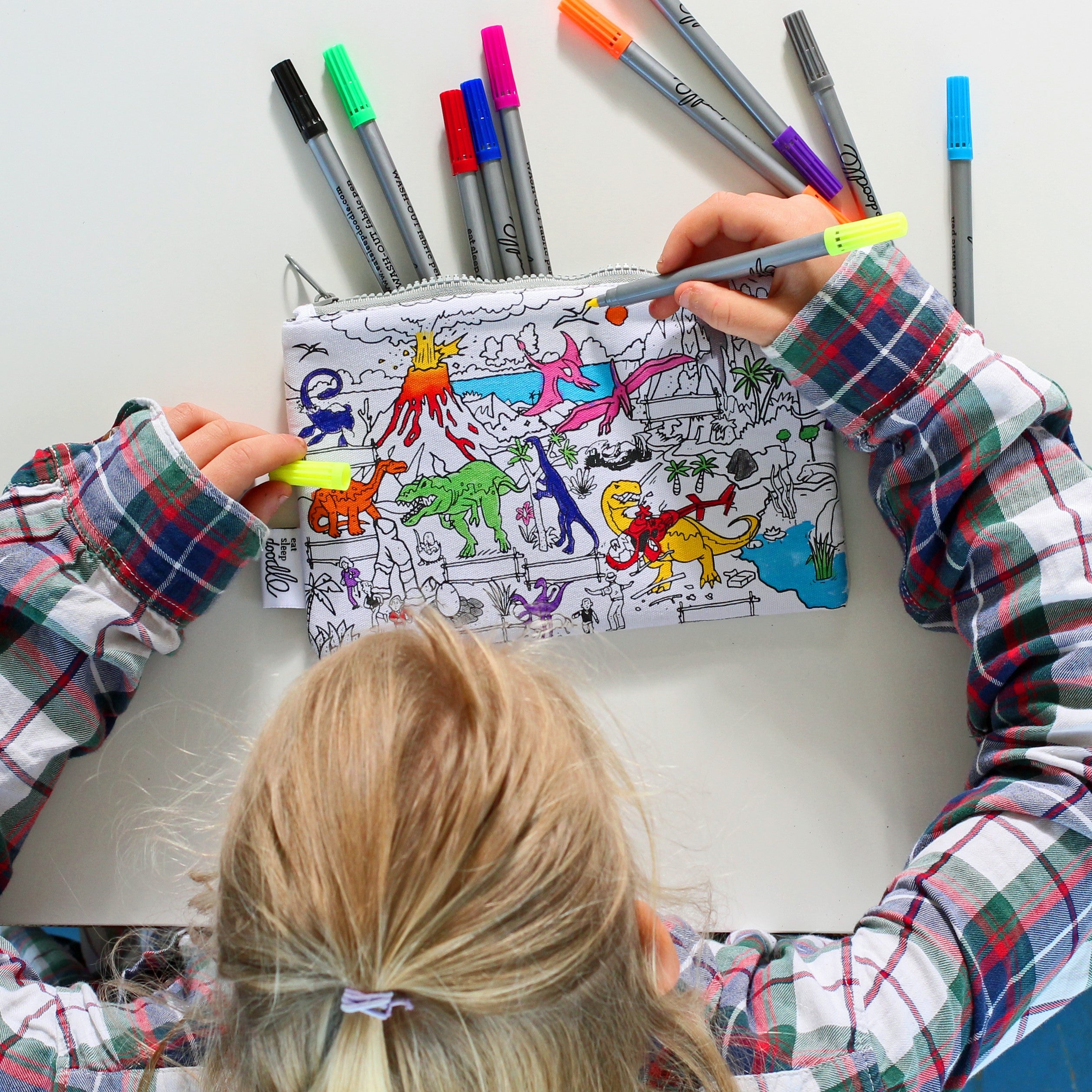 girl colouring in dinosaur pencil case with eatsleepdoodle pens