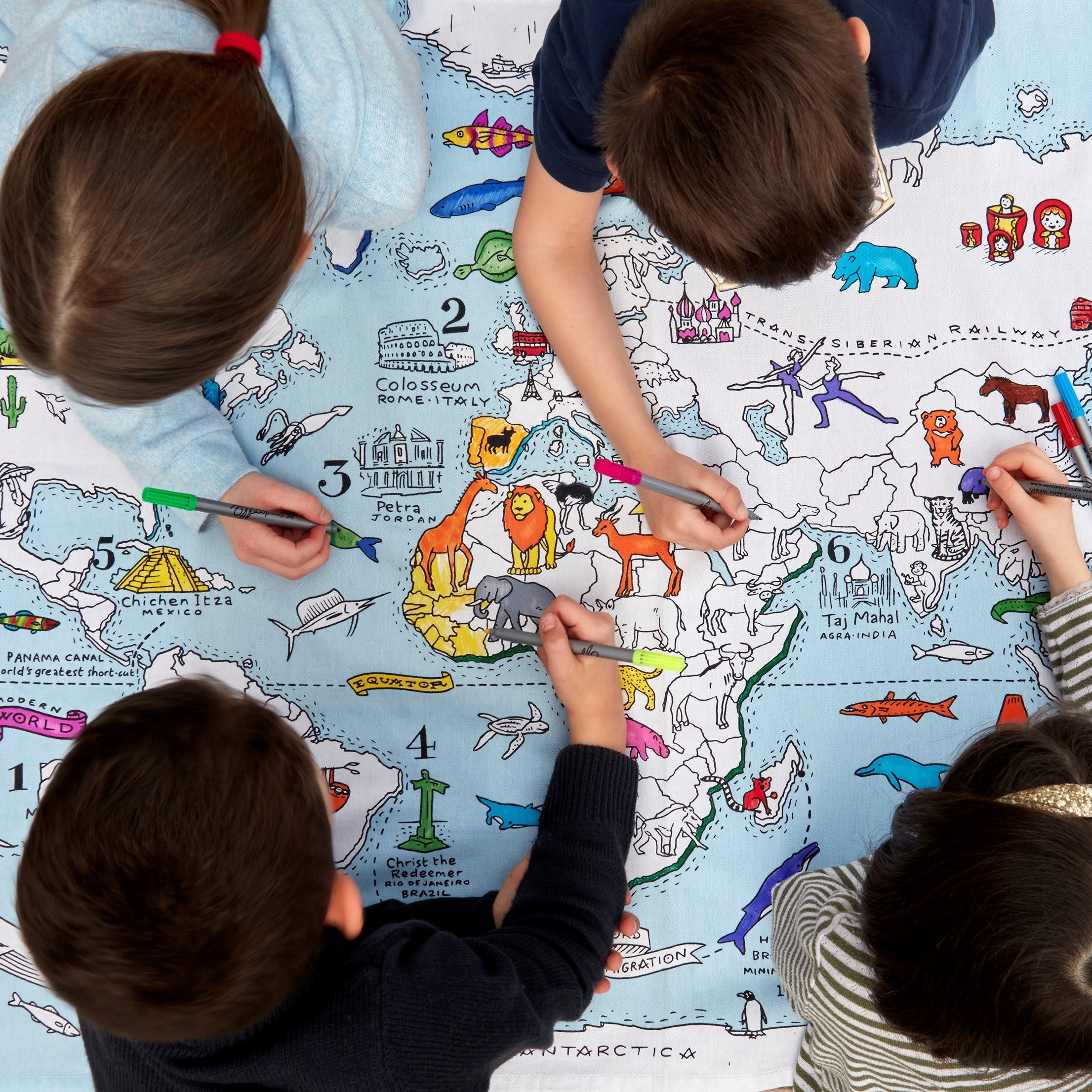 four children colouring in world map