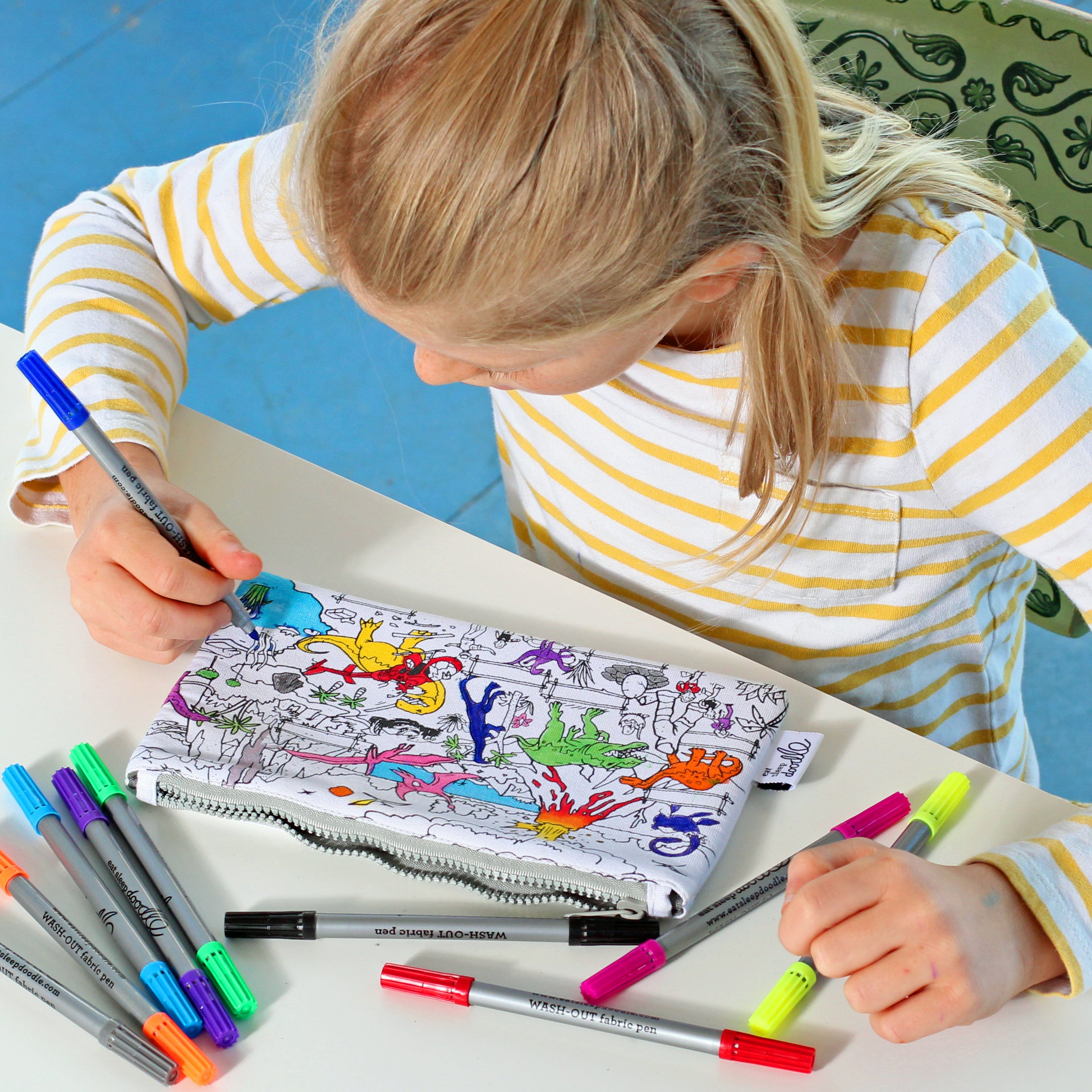girl colouring in dinosaur pencil case